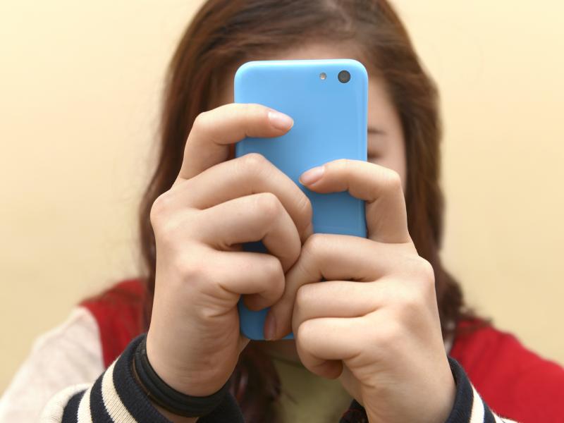 Close up of a teenager on her smartphone. Close up of a teenager on her smartphone.