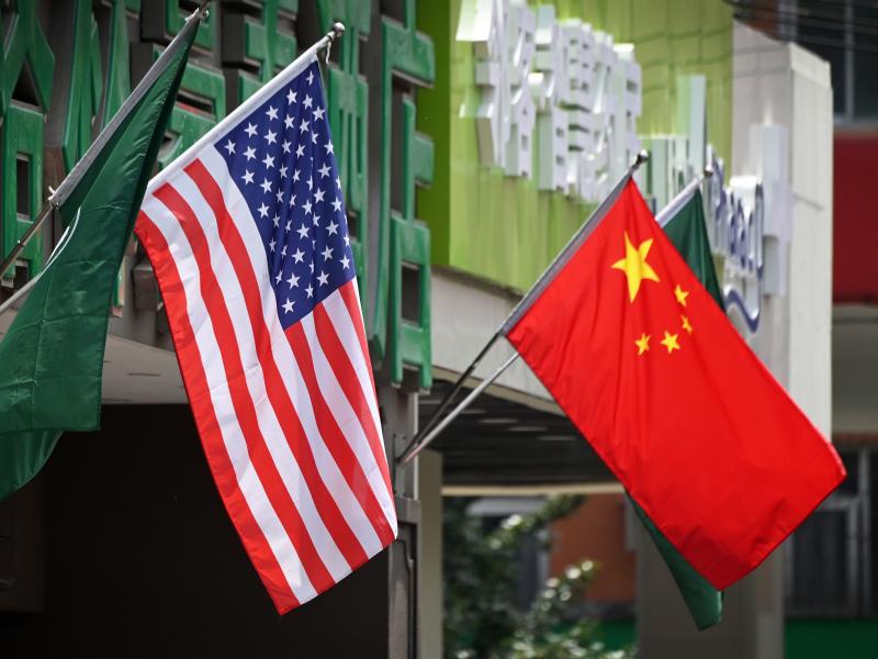 The US (L) and Chinese flags are displayed outside a hotel in Beijing on May 14, 2019. The US (L) and Chinese flags are displayed outside a hotel in Beijing on May 14, 2019.