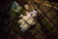 Police officers launch smoke bombs and tear gas to clear out protesters who shut down highway I-94 on Saturday in St. Paul, Minnesota. Police officers launch smoke bombs and tear gas to clear out protesters who shut down highway I-94 on Saturday in St. Paul, Minnesota.