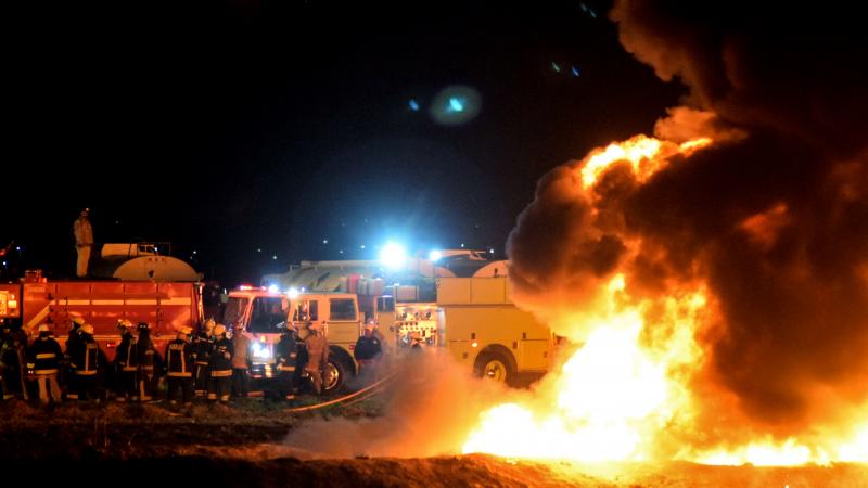 Firefighters work to extinguish a massive blaze triggered by a leaking pipeline in Tlahuelilpan, Mexico on Friday night. At least 66 people were killed. Firefighters work to extinguish a massive blaze triggered by a leaking pipeline in Tlahuelilpan, Mexico on Friday night. At least 66 people were killed.