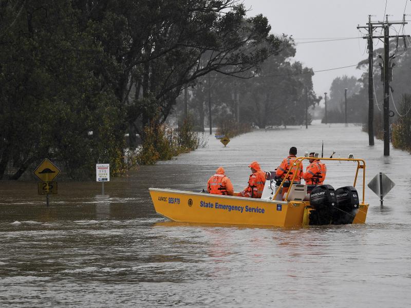 A New South Wales State Emergency Service (SES) crew is seen in a rescue boat as roads are submerged under floodwater from the swollen Hawkesbury River in Windsor, northwest of Sydney, Monday, July 4, 2022. A New South Wales State Emergency Service (SES) crew is seen in a rescue boat as roads are submerged under floodwater from the swollen Hawkesbury River in Windsor, northwest of Sydney, Monday, July 4, 2022.