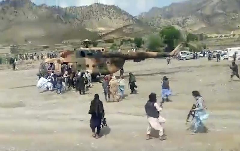 In this image taken from video from Bakhtar State News Agency, Taliban fighters secure a government helicopter to evacuate injured people in Gayan district, Paktika province, Afghanistan, Wednesday, June 22, 2022. In this image taken from video from Bakhtar State News Agency, Taliban fighters secure a government helicopter to evacuate injured people in Gayan district, Paktika province, Afghanistan, Wednesday, June 22, 2022.