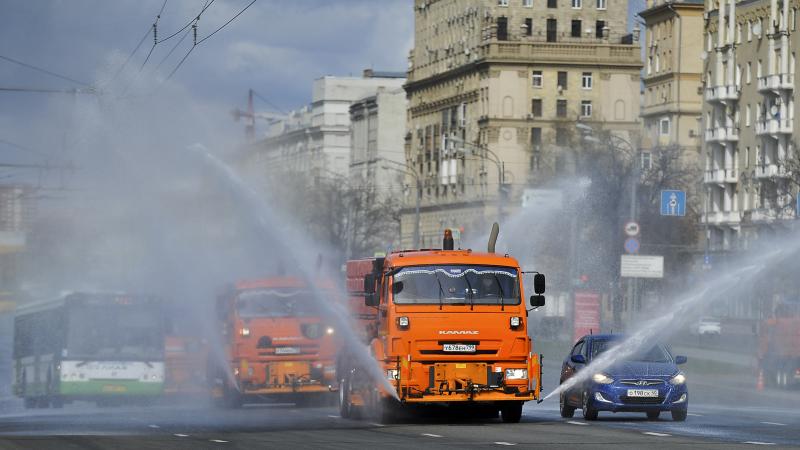 Municipal tankers spray disinfectant as a precaution against the coronavirus in Moscow on Sunday. Most of Russia's COVID-19 cases have been recorded in Moscow. Municipal tankers spray disinfectant as a precaution against the coronavirus in Moscow on Sunday. Most of Russia's COVID-19 cases have been recorded in Moscow.