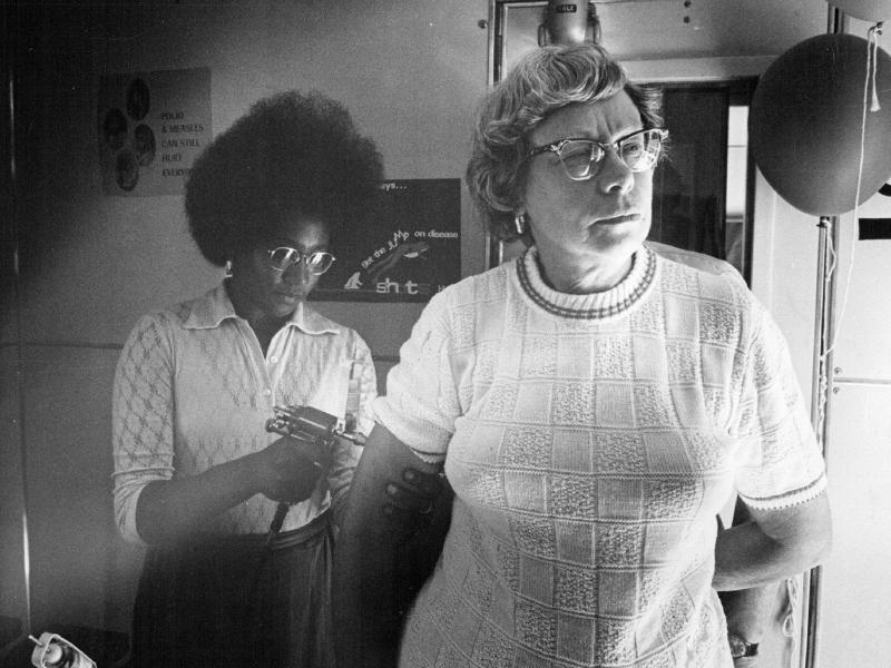 Jackie Carnegie immunizes Mabel Haywood in a Colorado Health Department immunization van in 1972. Shots for measles and other infectious diseases were offered. Jackie Carnegie immunizes Mabel Haywood in a Colorado Health Department immunization van in 1972. Shots for measles and other infectious diseases were offered.