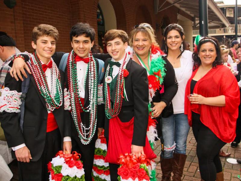As they travel the parade route, tuxedoed men and youths distribute strings of colorful beads, dried fava beans and genuine Italian kisses. As they travel the parade route, tuxedoed men and youths distribute strings of colorful beads, dried fava beans and genuine Italian kisses.