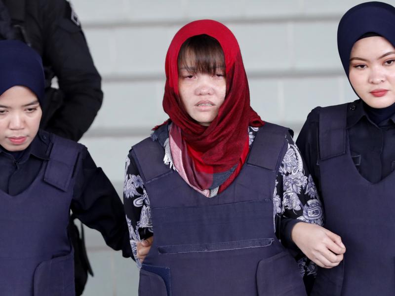 Vietnamese Doan Thi Huong, center, is escorted by police as she leaves Shah Alam High Court in Malaysia on Thursday. Malaysia's attorney general ordered the murder case to proceed against the Vietnamese woman accused in the killing of the North Korean lea Vietnamese Doan Thi Huong, center, is escorted by police as she leaves Shah Alam High Court in Malaysia on Thursday. Malaysia's attorney general ordered the murder case to proceed against the Vietnamese woman accused in the killing of the North Korean lea