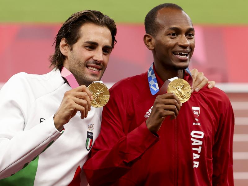 Gold medalists Gianmarco Tamberi of Italy and Mutaz Essa Barshim of Qatar shared the podium after the men's high jump at the Tokyo 2020 Olympic Games at Olympic Stadium. Gold medalists Gianmarco Tamberi of Italy and Mutaz Essa Barshim of Qatar shared the podium after the men's high jump at the Tokyo 2020 Olympic Games at Olympic Stadium.