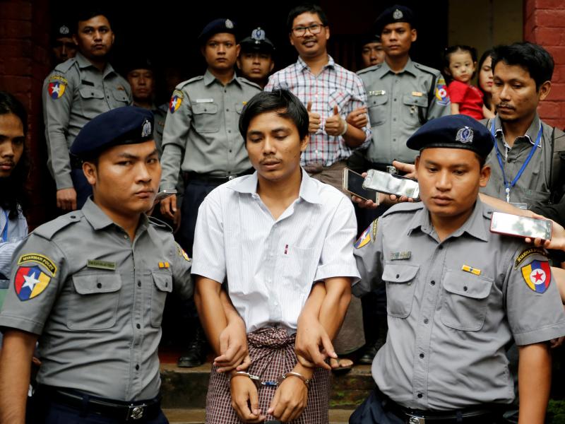 Reuters journalists Kyaw Soe Oo and Wa Lone were escorted by police after a court hearing in August 2018 in Yangon, Myanmar. Reuters journalists Kyaw Soe Oo and Wa Lone were escorted by police after a court hearing in August 2018 in Yangon, Myanmar.