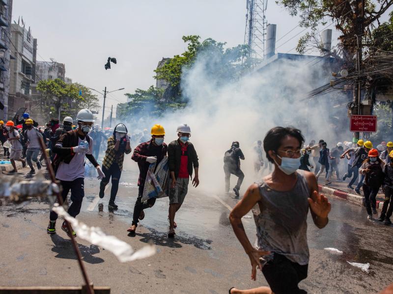 Anti-junta protesters run from teargas fired by police during a demonstration in Yangon on Monday. At least 18 people were killed over the weekend as Myanmar police reportedly used live ammunition against protesters. Anti-junta protesters run from teargas fired by police during a demonstration in Yangon on Monday. At least 18 people were killed over the weekend as Myanmar police reportedly used live ammunition against protesters.