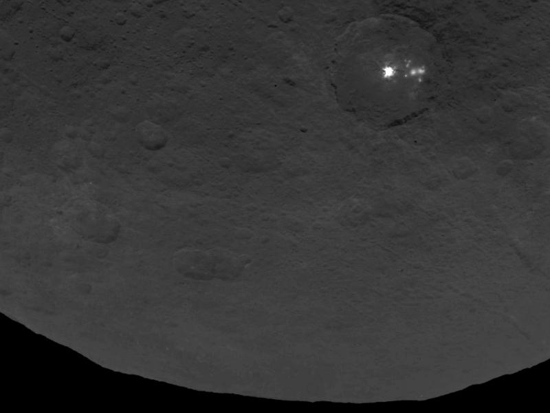 A "cluster of mysterious bright spots" can be seen on the dwarf planet Ceres, NASA says. The image was taken by the Dawn spacecraft, in orbit of Ceres. A "cluster of mysterious bright spots" can be seen on the dwarf planet Ceres, NASA says. The image was taken by the Dawn spacecraft, in orbit of Ceres.