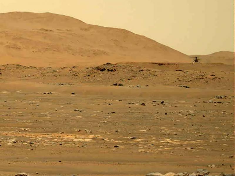 In this image taken by the Mars Perseverance rover and made available by NASA, the Mars Ingenuity helicopter, right, flies over the surface of the planet on Friday. In this image taken by the Mars Perseverance rover and made available by NASA, the Mars Ingenuity helicopter, right, flies over the surface of the planet on Friday.