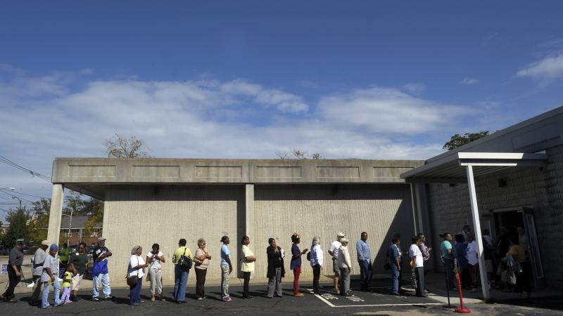People wait in line to vote at the Board of Elections early voting site on Oct. 18, 2012, in Wilson, N.C. The U.S. Justice Department and several groups are suing North Carolina over the sweeping election overhaul it passed two years ago. People wait in line to vote at the Board of Elections early voting site on Oct. 18, 2012, in Wilson, N.C. The U.S. Justice Department and several groups are suing North Carolina over the sweeping election overhaul it passed two years ago.