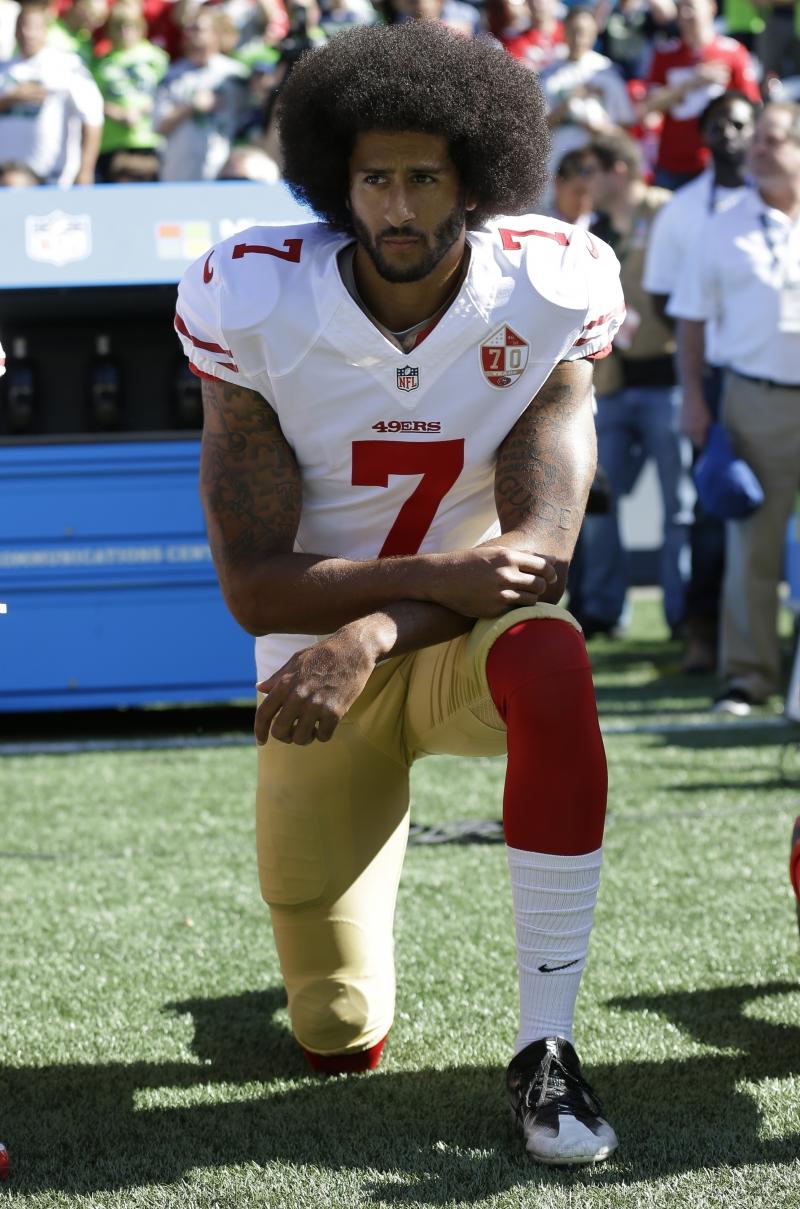 Then-San Francisco 49ers quarterback Colin Kaepernick kneels during the national anthem before a September 2016 game against the Seattle Seahawks in Seattle. Then-San Francisco 49ers quarterback Colin Kaepernick kneels during the national anthem before a September 2016 game against the Seattle Seahawks in Seattle.