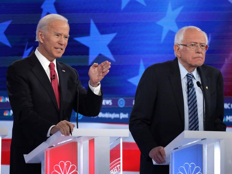 Former Vice President Joe Biden (left) and Sen. Bernie Sanders lead the crowded Democratic presidential primary field, according to the latest NPR/PBS NewsHour/Marist Poll. Above, they appear during the Democratic presidential primary debate in Atlanta on Former Vice President Joe Biden (left) and Sen. Bernie Sanders lead the crowded Democratic presidential primary field, according to the latest NPR/PBS NewsHour/Marist Poll. Above, they appear during the Democratic presidential primary debate in Atlanta on