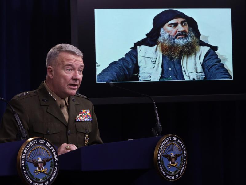 Marine Corps Gen. Kenneth McKenzie, commander of U.S. Central Command, speaks as a picture of Abu Bakr al-Baghdadi is displayed during a news briefing on Oct. 30, 2019, at the Pentagon in Arlington, Virginia. McKenzie spoke to reporters to provide an upda Marine Corps Gen. Kenneth McKenzie, commander of U.S. Central Command, speaks as a picture of Abu Bakr al-Baghdadi is displayed during a news briefing on Oct. 30, 2019, at the Pentagon in Arlington, Virginia. McKenzie spoke to reporters to provide an upda