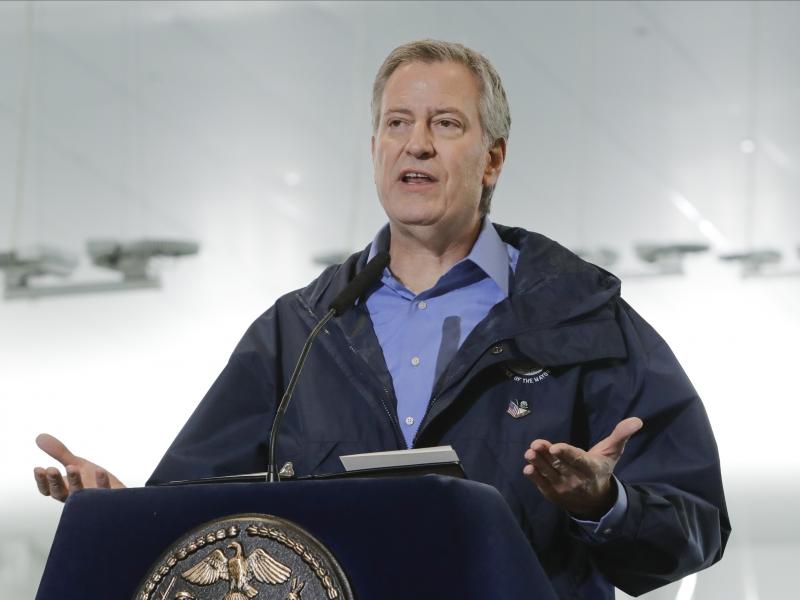 New York City Mayor Bill de Blasio speaks on March 31, 2020 at the USTA Indoor Training Center, the site of a makeshift hospital in New York. De Blasio is calling for a national enlistment program for doctors and nurses. New York City Mayor Bill de Blasio speaks on March 31, 2020 at the USTA Indoor Training Center, the site of a makeshift hospital in New York. De Blasio is calling for a national enlistment program for doctors and nurses.