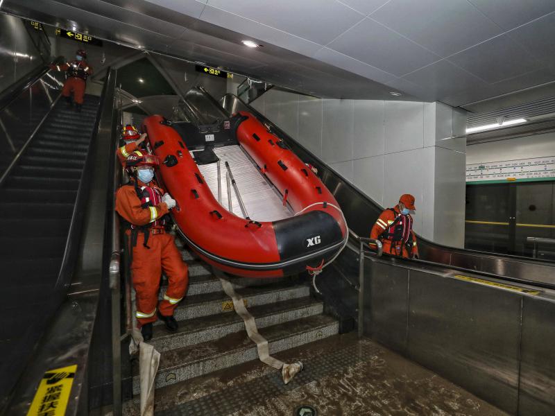 Rescuers carry a boat into the subway in Zhengzhou, China, in July after flash floods trapped passengers underground. Rescuers carry a boat into the subway in Zhengzhou, China, in July after flash floods trapped passengers underground.