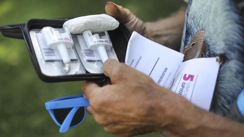 A man checks out an anti-overdose kit he was given at a clinic. With America confronting an opioid epidemic, Walgreens says it will stock naloxone spray at all of its pharmacies. A man checks out an anti-overdose kit he was given at a clinic. With America confronting an opioid epidemic, Walgreens says it will stock naloxone spray at all of its pharmacies.