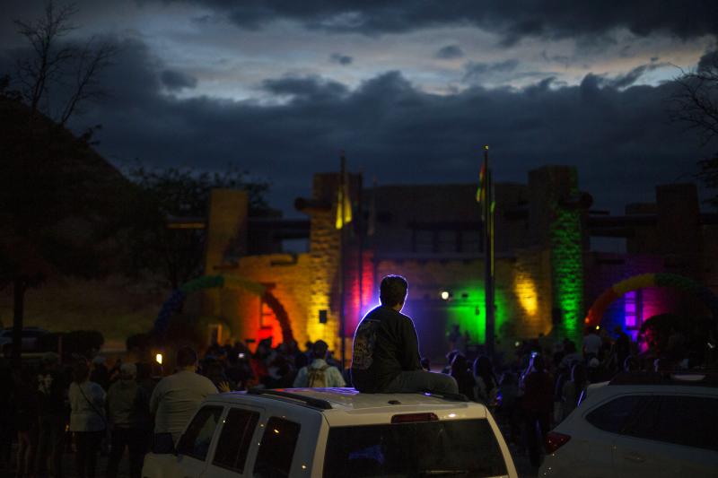 Matthew Slick is silhouetted by the purple light as the Navajo Council Chamber is lit in rainbow colors for Pride on June 28 in Window Rock, Ariz., the capital of the Navajo Nation. Matthew Slick is silhouetted by the purple light as the Navajo Council Chamber is lit in rainbow colors for Pride on June 28 in Window Rock, Ariz., the capital of the Navajo Nation.
