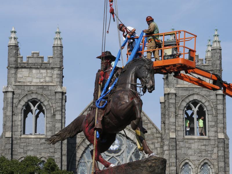 Crews attach straps in July to the statue of Confederate Gen. J.E.B. Stuart in Richmond, Va. The statue was one of several that were removed by the city in 2020 following nationwide protests against systemic racism. Crews attach straps in July to the statue of Confederate Gen. J.E.B. Stuart in Richmond, Va. The statue was one of several that were removed by the city in 2020 following nationwide protests against systemic racism.