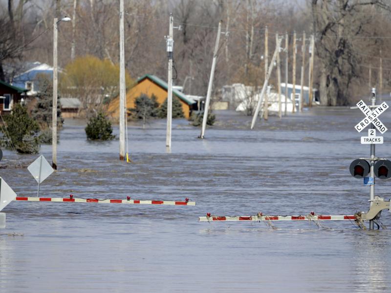 A railroad crossing is flooded with water from the Platte River in Plattsmouth, Neb. Record high floodwaters inundated regions of the Midwest following an intense winter storm and rapid snowmelt. A railroad crossing is flooded with water from the Platte River in Plattsmouth, Neb. Record high floodwaters inundated regions of the Midwest following an intense winter storm and rapid snowmelt.