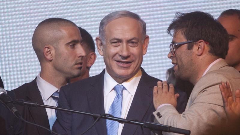 Israeli Prime Minister Benjamin Netanyahu (center) speaks to supporters at his election headquarters on Tuesday in Tel Aviv. He now appears headed for a fourth term in office, but his campaign pledges could lead to increased friction with the Palestinian Israeli Prime Minister Benjamin Netanyahu (center) speaks to supporters at his election headquarters on Tuesday in Tel Aviv. He now appears headed for a fourth term in office, but his campaign pledges could lead to increased friction with the Palestinian