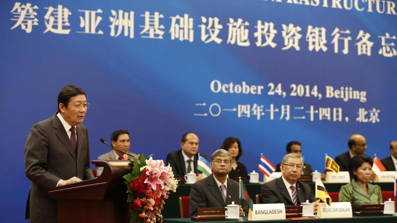 Chinese Finance Minister Lou Jiwei (left) speaks during the signing ceremony of the Asian Infrastructure Investment Bank, Oct. 24, in Beijing. Chinese Finance Minister Lou Jiwei (left) speaks during the signing ceremony of the Asian Infrastructure Investment Bank, Oct. 24, in Beijing.