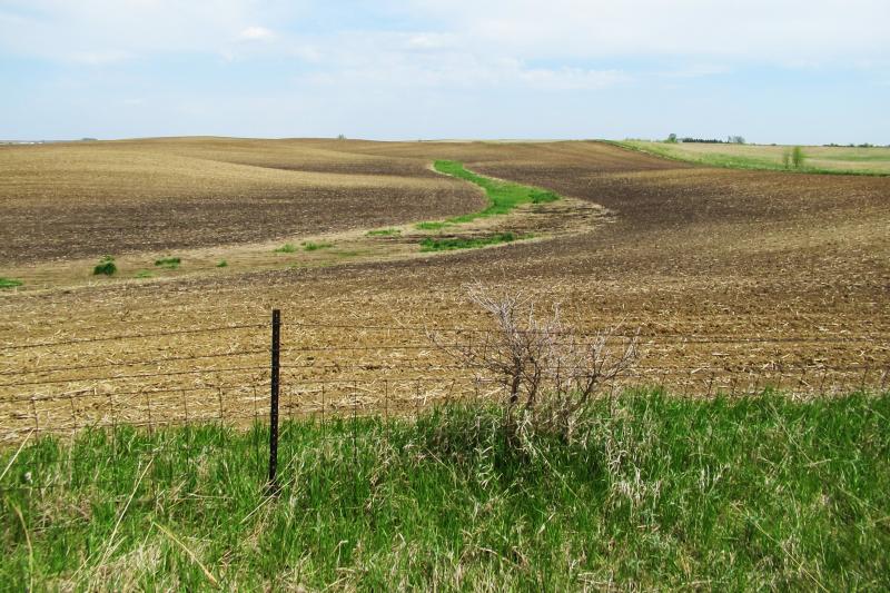 Soil on hilltops in this photo is lighter in color, revealing a loss of fertile topsoil. Soil on hilltops in this photo is lighter in color, revealing a loss of fertile topsoil.