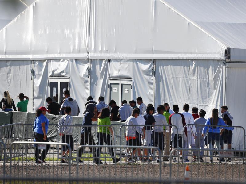 Migrant children line up to enter a tent at the Homestead Temporary Shelter for Unaccompanied Children in Homestead, Fla. in February 2019. Migrant children line up to enter a tent at the Homestead Temporary Shelter for Unaccompanied Children in Homestead, Fla. in February 2019.