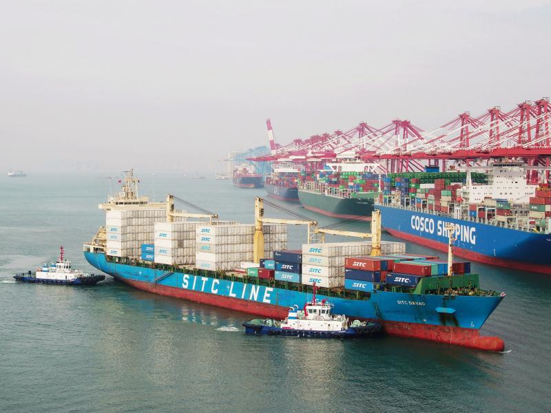 A cargo ship prepares to berth at a port in Qingdao in China's eastern Shandong province on Wednesday. New tariffs went into effect Friday. A cargo ship prepares to berth at a port in Qingdao in China's eastern Shandong province on Wednesday. New tariffs went into effect Friday.