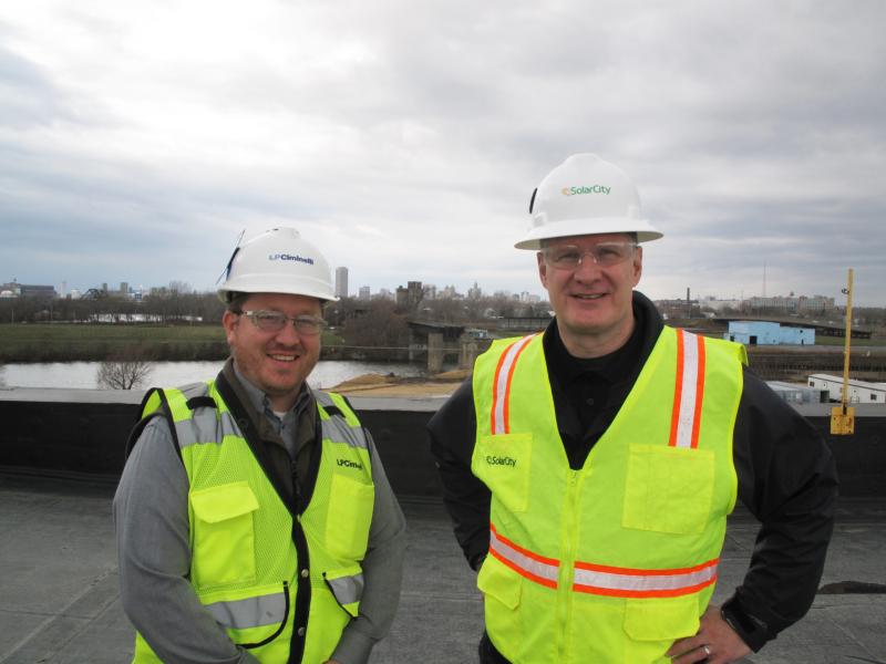 David Vawter (left), project manager at LPCiminelli and Steve James, senior vice president of Operations at SolarCity, on the roof of the factory in South Buffalo. David Vawter (left), project manager at LPCiminelli and Steve James, senior vice president of Operations at SolarCity, on the roof of the factory in South Buffalo.