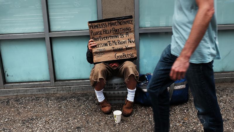 A homeless man panhandles along Manhattan's Eighth Avenue in New York City. A homeless man panhandles along Manhattan's Eighth Avenue in New York City.