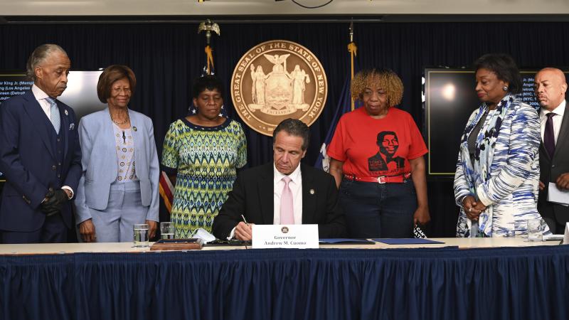 New York Gov. Andrew Cuomo, center, signs into law a sweeping package of police accountability measures on Friday that received new backing following protests of George Floyd's killing. New York Gov. Andrew Cuomo, center, signs into law a sweeping package of police accountability measures on Friday that received new backing following protests of George Floyd's killing.