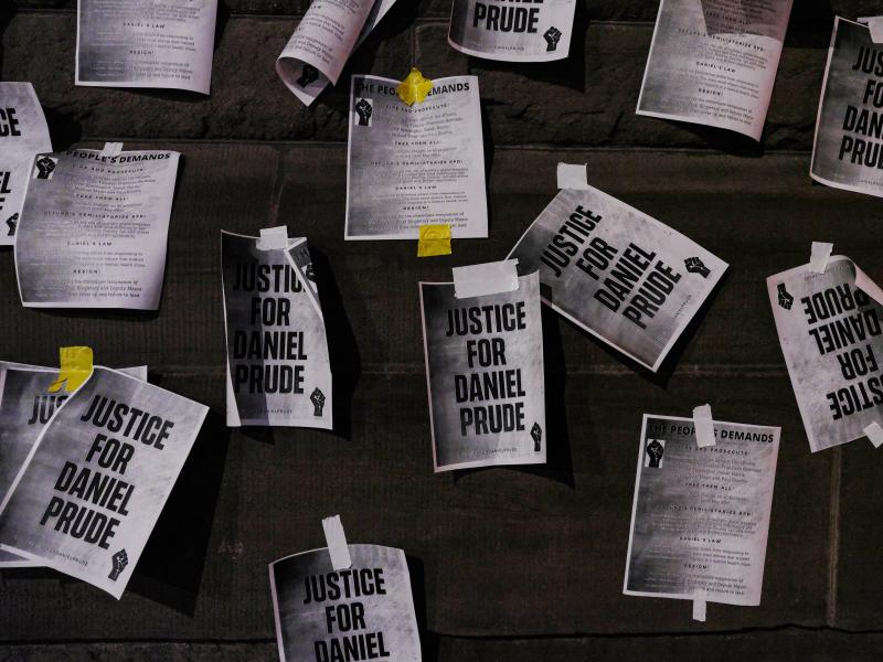 Signs calling for "Justice for Daniel Prude" were plastered to the exterior walls of City Hall in Rochester, N.Y., on Sept. 8, the seventh consecutive night of protests following the release of bodycam footage showing the March arrest that preceded his de Signs calling for "Justice for Daniel Prude" were plastered to the exterior walls of City Hall in Rochester, N.Y., on Sept. 8, the seventh consecutive night of protests following the release of bodycam footage showing the March arrest that preceded his de