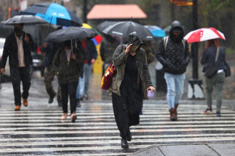 Rain falls as people cross the street during an autumn Nor'easter on Tuesday in the Brooklyn borough of New York City. New York and New Jersey declared states of emergency as the storm brought heavy rain and strong winds to the area. Rain falls as people cross the street during an autumn Nor'easter on Tuesday in the Brooklyn borough of New York City. New York and New Jersey declared states of emergency as the storm brought heavy rain and strong winds to the area.