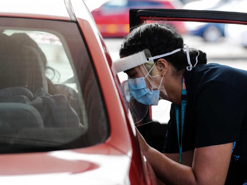A Health worker administers vaccinations at a pop-up drive-in clinic Monday, Oct. 11, 2021, in Auckland, New Zealand. New Zealand's doctors and teachers are among those who must soon be fully vaccinated against the coronavirus to continue working in their A Health worker administers vaccinations at a pop-up drive-in clinic Monday, Oct. 11, 2021, in Auckland, New Zealand. New Zealand's doctors and teachers are among those who must soon be fully vaccinated against the coronavirus to continue working in their
