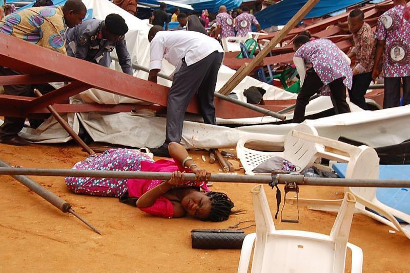 A woman lies under a scaffolding bar Saturday after the collapse at a church in the remote southeastern city of Uyo, the capital of Nigeria's Akwa Ibom state. A woman lies under a scaffolding bar Saturday after the collapse at a church in the remote southeastern city of Uyo, the capital of Nigeria's Akwa Ibom state.