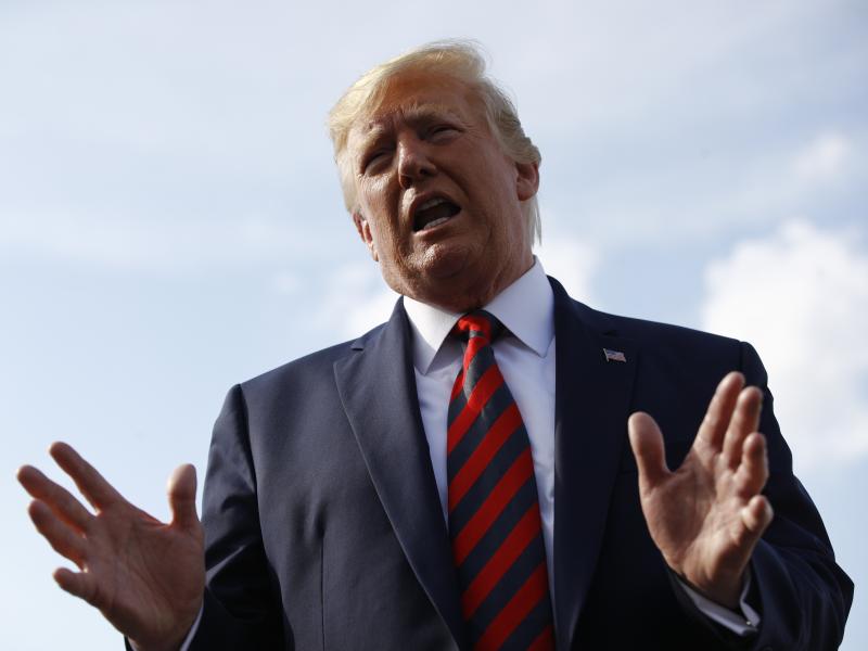 President Trump speaks with reporters before boarding Air Force One with first lady Melania Trump at Morristown Municipal Airport in Morristown, N.J., on Sunday. President Trump speaks with reporters before boarding Air Force One with first lady Melania Trump at Morristown Municipal Airport in Morristown, N.J., on Sunday.