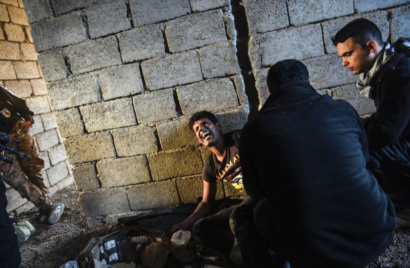 Medics tend to an Iraqi counterterrorism fighter injured in a clash with ISIS forces near the village of Bazwaya, on the eastern edge of Mosul. Medics tend to an Iraqi counterterrorism fighter injured in a clash with ISIS forces near the village of Bazwaya, on the eastern edge of Mosul.