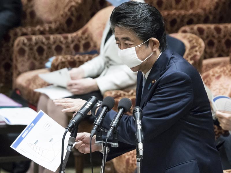 Japan's Prime Minister Shinzo Abe, seen in parliament on Tuesday in Tokyo, said it would be "impossible" to hold the already delayed Summer Olympics and Paralympics in 2021 if the disease is not brought under control. Japan's Prime Minister Shinzo Abe, seen in parliament on Tuesday in Tokyo, said it would be "impossible" to hold the already delayed Summer Olympics and Paralympics in 2021 if the disease is not brought under control.