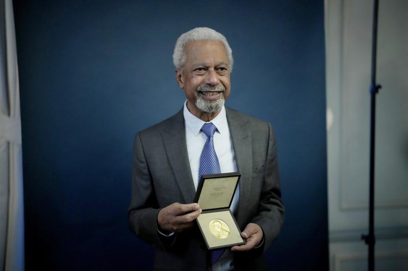 Abdulrazak Gurnah, a Tanzanian-born novelist and academic who lives in the U.K., poses with his 2021 Nobel Prize in Literature medal after being presented it at the Swedish ambassador's residence in London. Abdulrazak Gurnah, a Tanzanian-born novelist and academic who lives in the U.K., poses with his 2021 Nobel Prize in Literature medal after being presented it at the Swedish ambassador's residence in London.