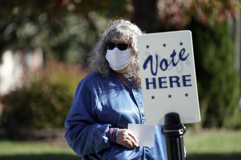 A voter waits to cast a ballot at the Graham Civic Center polling location in Graham, N.C., Nov. 3, 2020. On Dec. 8, 2021, the North Carolina Supreme Court delayed the 2022 statewide primaries by two months to give redistricting legal challenges more time A voter waits to cast a ballot at the Graham Civic Center polling location in Graham, N.C., Nov. 3, 2020. On Dec. 8, 2021, the North Carolina Supreme Court delayed the 2022 statewide primaries by two months to give redistricting legal challenges more time