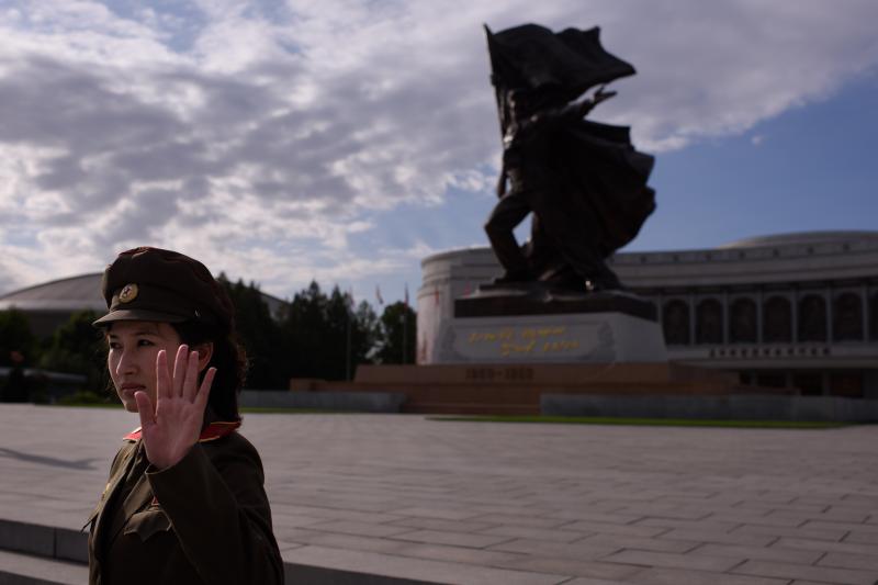 A uniformed tour guide gestures to tourists outside the War Museum in Pyongyang. U.S. citizens can visit North Korea as tourists. A uniformed tour guide gestures to tourists outside the War Museum in Pyongyang. U.S. citizens can visit North Korea as tourists.