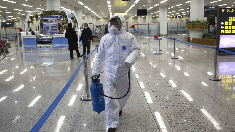 North Korean State Commission of Quality Management staff in protective gear carries a disinfectant spray can as personnel check the health of travelers and inspect goods delivered via the borders at the Pyongyang Airport in North Korea, on Feb. 1. North Korean State Commission of Quality Management staff in protective gear carries a disinfectant spray can as personnel check the health of travelers and inspect goods delivered via the borders at the Pyongyang Airport in North Korea, on Feb. 1.