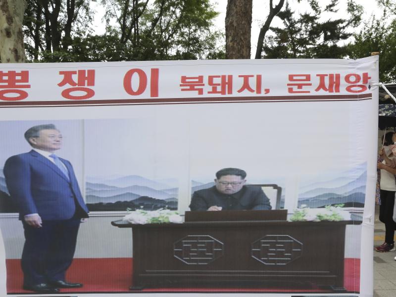 A banner showing a photo of North Korean leader Kim Jong Un and South Korean President Moon Jae-in, left, was displayed to denounce policies of Moon on North Korea in Seoul, South Korea. A banner showing a photo of North Korean leader Kim Jong Un and South Korean President Moon Jae-in, left, was displayed to denounce policies of Moon on North Korea in Seoul, South Korea.