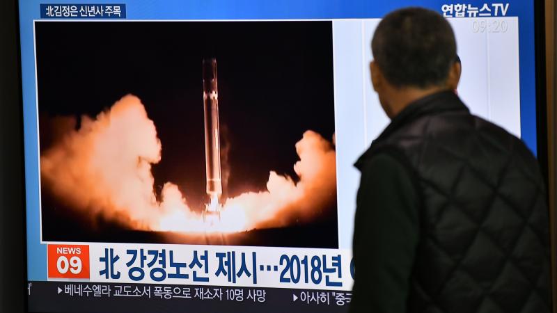 A man watches TV news at a railroad station on Jan. 1 in Seoul, South Korea. While waiting for North Korea's leader to address his nuclear-weapons plans, the program featured file footage of a North Korean missile test. A man watches TV news at a railroad station on Jan. 1 in Seoul, South Korea. While waiting for North Korea's leader to address his nuclear-weapons plans, the program featured file footage of a North Korean missile test.
