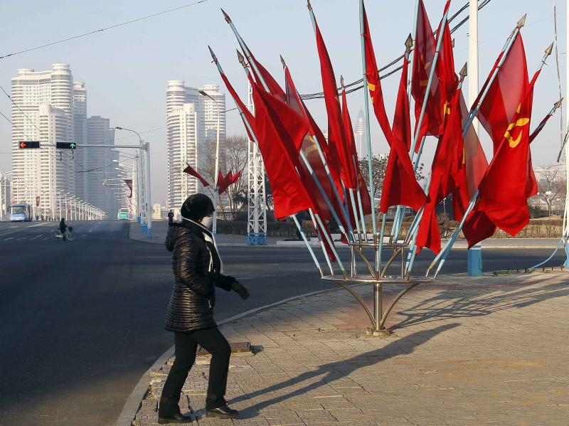 A person passes by a bouquet of Workers Party flags along a main street of the Central District in Pyongyang, North Korea, last week. A person passes by a bouquet of Workers Party flags along a main street of the Central District in Pyongyang, North Korea, last week.