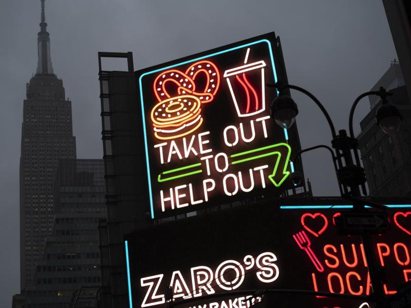A billboard in midtown Manhattan reads "Take Out To Help Out, last month in New York. A billboard in midtown Manhattan reads "Take Out To Help Out, last month in New York.
