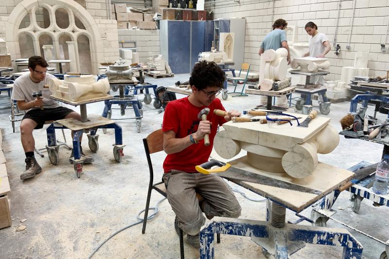 Students chip and chisel away at heavy slabs of stone in the workshops of the Hector Guimard high school, less than three miles from Paris' Notre Dame cathedral. Students chip and chisel away at heavy slabs of stone in the workshops of the Hector Guimard high school, less than three miles from Paris' Notre Dame cathedral.