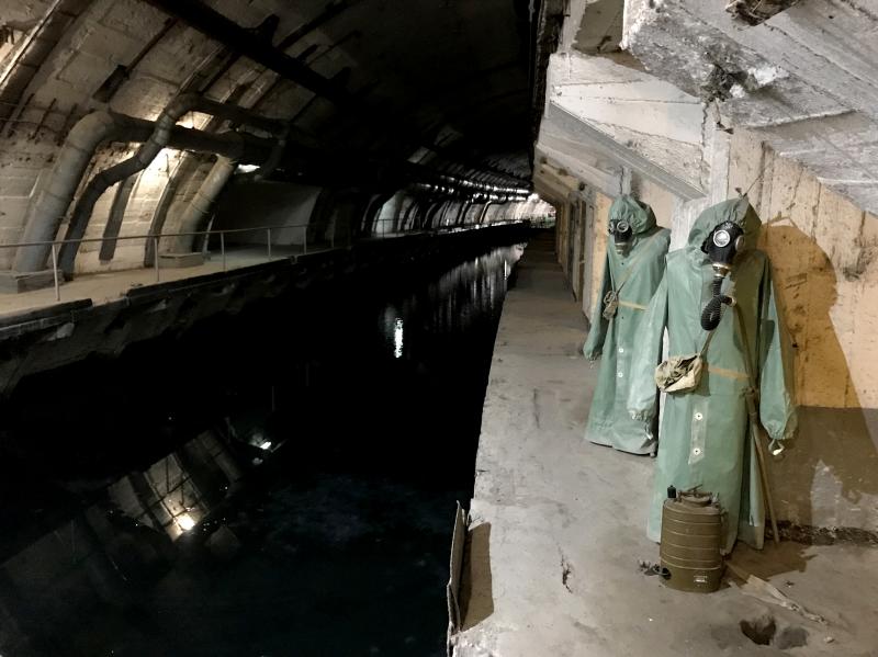 Hazmat suits hang next to the canal that leads from Balaklava Bay to the heart of the underground base. Hazmat suits hang next to the canal that leads from Balaklava Bay to the heart of the underground base.